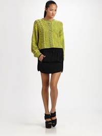 Heathered wool woven in a geometric jacquard, slightly oversized and cropped at the waist.Ribbed crewneckDropped shouldersGathered cuffsPullover styleAbout 20 from shoulder to hem63% wool/29% viscose/7% nylon/1% spandexDry cleanImported