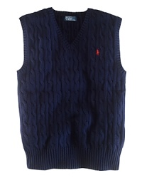 The essential sweater vest is a handsome layer rendered in durable cable-knit cotton.