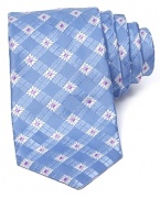 A squared floral print makes a statement on a silk tie from Ike Behar.