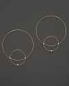 Like magic, smaller hoops balance on 14K gold counterparts.