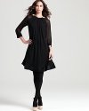 Luxe embellishment and sheer sleeves lend opulent edge to a pleated RAOUL dress, styled with black tights for a captivating cocktail look.