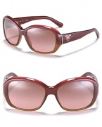 Elegant oversized sunglasses with oval frames and signature logo detail at temples.