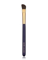 Angled brush sweeps on powder eyeshadow for allover base application plus definition on the outer lid and crease.