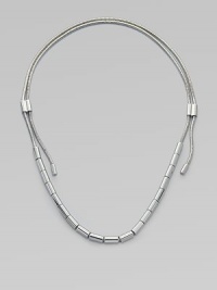 An edgy piece in sleek silvertone with oblong beads on a textured snake chain. Silvertone brassLength, about 37Sliding adjustable slip-on styleImported 