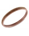 Subtle chic. Givenchy's bangle bracelet, crafted from rose gold-tone mixed metal, dazzles with light Colorado and smoked topaz tone glass accents. Approximate diameter: 2-1/2 inches.