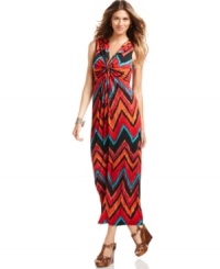 A gathered knot and bold allover print add a graphic pop to NY Collection's stretch jersey maxi dress. Dress it up with wedge sandals to flirty effect.