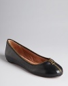 A decorative brass-tone zipper adds a quirky touch to Corso Como's Fabienne flats, slick in glossy leather.