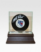 After a grueling 54 years without the Stanley Cup and seven stomach-churning finals games, the New York Rangers finally conquered the championship in 1994. As goaltender for the Rangers, Mike Richter's unwavering performance proved an essential part of the winning equation. Mike Richter has hand-signed this New York Rangers hockey puck and arrives in a glass/wood display case. Includes certificate of authenticity 8 X 8 X 8 Made in USA 