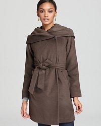 Flaunt subtle sheen and chic seam detail in this Elie Tahari statement coat-a seasonal standout designed with an oversized shawl collar that coverts to a cozy hood for inclement days. With an asymmetric front closure, this luxe layer is a winter's must.