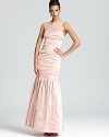 Boasting delicate lace details and a dropwaist silhouette, BCBGMAXAZRIA's feminine gown makes a grand entrance.