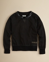 Sequins and goldtone trim transform a class sweatshirt from GUESS.