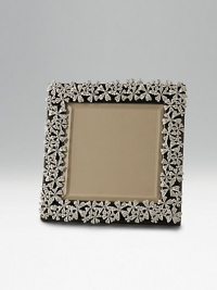 Polished and platinum-plated with ornate garland design. Leather back Arrives handsomely gift boxed