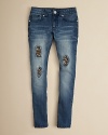 GUESS transforms a skinny jean with heaving fading and holes patched with leopard print sequins.