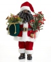 St. Nick sure has his hands full. Carrying beautiful trim and trees, this holiday-perfect Santa Claus figurine makes a special Christmas delivery in his traditional red and white getup.