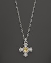 A gleaming canary crystal is set at the center of an ornate cross on this Judith Ripka pendant necklace.