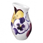 Pensees creamer by Bernardaud. This lively, luxurious collection is sure to transform your table into a celebration of spring. The floral watercolor pattern features delicate, multicolored pansies that appear to be strewn across the surface of each piece.