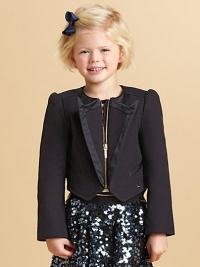 A tux deluxe for your little lass, complete with a swallowtail hem.Jewel necklineZip frontSatin-edged peaked lapelsSatin-piped welt pocketsLong sleeves with button detailed cuffsButtoned belt at back waistCotton/SpandexDry cleanImported