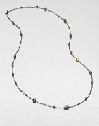 From the Bijoux Collection. Richly colored semi-precious stones in various colors and shapes mix with 18k gold beads on a delicate blackened sterling silver link chain. Hematite, labordarite, grey moonstone and blue topaz18k goldBlackened sterling silverLength, about 40Toggle closureImported 