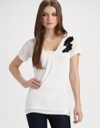 A wardrobe constant goes from simple to sophisticated, with its beautifully embellished lace appliqué.V-neck Pullover style Short sleeves Floral lace appliqué with sequins and beads About 27¼ from shoulder to hem Modal; hand wash Imported