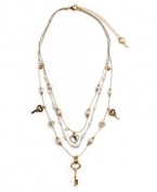 Simple and sweet. A dainty three-layer illusion necklace by Betsey Johnson features delicate chains decorated with acrylic pearls, crystal keys, and heart charms. Crafted in silver and gold tone mixed metal. Approximate length: 16 inches + 3-inch extender. Approximate drop: 3 inches.