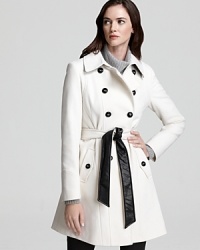 A military-inspired DKNY coat flaunts faux leather details and a two-tone belt for a fashion-forward look that's truly eye-catching. Work the on-trend silhouette with your workday ensembles and master this editorial favorite.