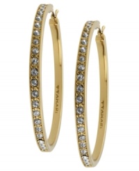 Go big this season. T Tahari blends golden tones with shimmering crystal studs on these large hoop earrings. Crafted in gold tone mixed metal. Base metal is nickel-free for sensitive skin. Approximate diameter: 1-1/4 inch.