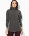 A feminine turtleneck sweater is crafted from indulgent cashmere with relaxed dolman sleeves for effortless style.