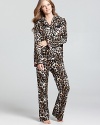 Dream of safaris and exotic lands in Betsey Johnson's flannel pajama set with contrast bow details.