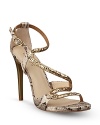 Channel your inner Cleopatra in these sensual, strappy sandals, mixing golden and snake-embossed leather for a timelessly regal effect; by GUESS.