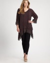 You will not want to take off this flowing, flattering tunic featuring exquisite embroidered details. V-necklineLong sleevesDropped shouldersEmbroidered trimHi-lo hemAbout 35 from shoulder to hemRayonMachine washImported