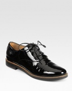 A menswear-inspired silhouette in patent leather with charming laces. Stacked heel, 1 (25mm)Patent leather upperLeather liningRubber solePadded insoleMade in Italy