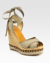 Secured by a grosgrain ribbon tie, this woven straw wedge has a canvas upper, hemp platform and studded leather trim. Straw wedge, 5 (125mm)Studded leather and hemp platform, 1½ (40mm)Compares to a 3½ heel (90mm)Canvas upperLeather lining and soleMade in SpainOUR FIT MODEL RECOMMENDS ordering true whole size; ½ sizes should order the next whole size up. 