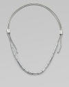 An edgy piece in sleek silvertone with oblong beads on a textured snake chain. Silvertone brassLength, about 37Sliding adjustable slip-on styleImported 