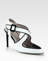 Dramatic two-tone silhouette in mirrored patent leather with interlacing crisscrossed straps. Lacquered heel, 3½ (90mm)Patent leather upperPoint toeAdjustable ankle strapLeather lining and solePadded insoleMade in Italy