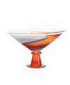 A unique piece that enhances a table or mantelpiece and serves as a majestic display for assorted fruit, this handcrafted bowl from one of the leading glass houses is graced with radiant hues of rust and orange ascending from base to mouth. 7 1/2 tall. Imported.