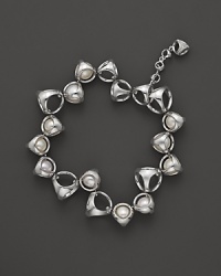 A bold sterling silver bracelet, gleaming with freshwater pearls, is an elegant showcase for Di MODOLO's iconic Triadra design.