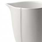 Borrowing from nature, this porcelain creamer has a highly glossed surface and unusual contours, creating an interesting silhouette - a DVF signature - on the table.