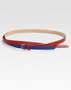 A graphic, colorblocked style with a cross-over design and a brass buckle. Width, about ½Made in Italy