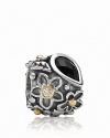 An onyx 'dew drop' stone grounds a sterling silver PANDORA charm with gold and diamond-accented floral motifs.