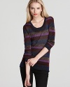 Sparkled stripes give this metallic sweater downtown credibility this season. The look's a natural with skinny black jeans.