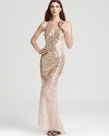 Dripping in glittering sequins, this Basix gown boasts a sheer skirt to reveal a hint of gorgeous gams.