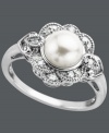 Vintage elegance. This stunning antique-inspired ring features an intricate round-cut diamond sunburst design (1/5 ct. t.w.) surrounding a cultured freshwater pearl (8 mm). Set in sterling silver. Size 7.