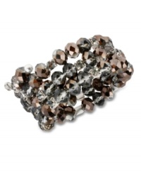 Hematite glass cherry beads adorn this moody coil bracelet from Kenneth Cole New York. Featuring black diamond crystal cup accents and glass crystals. Crafted in silver tone mixed metal. Approximate length: 7-1/2 inches.