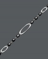 Decorate your wrist with the perfect finishing touch. This chic bracelet features a cut-out oval design accented by onyx beads (6 mm x 4 mm). Set in sterling silver. Approximate length: 7 inches.