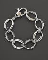 Sterling silver small smooth and fluted oval link bracelet with lobster closure. Designed by Lagos.