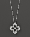 Diamonds set in a 14K. white gold flower pendant.