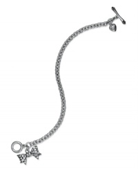 A beauty wrapped in bows. This toggle bracelet from Juicy Couture pretties up your look with bow and heart pendants embellished with shimmering pave accents. Crafted in silver tone mixed metal. Approximate length: 7-1/2 inches. Approximate drop length: 1-1/2 inches.