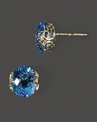 Faceted blue topaz in intricate 14K yellow gold settings.