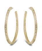 Star-studded style. This elegant pair of gold tone hoop earrings sparkles in clear Swarovski crystal pavé, reflecting the light beautifully and adding a touch of sophistication to any outfit. Approximate diameter: 1-7/8 inches.