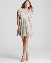 In shimmering metallic lace, BCBGMAXAZRIA's Cynthia dress makes a festive party choice when teamed with dazzling earrings and feminine pumps.